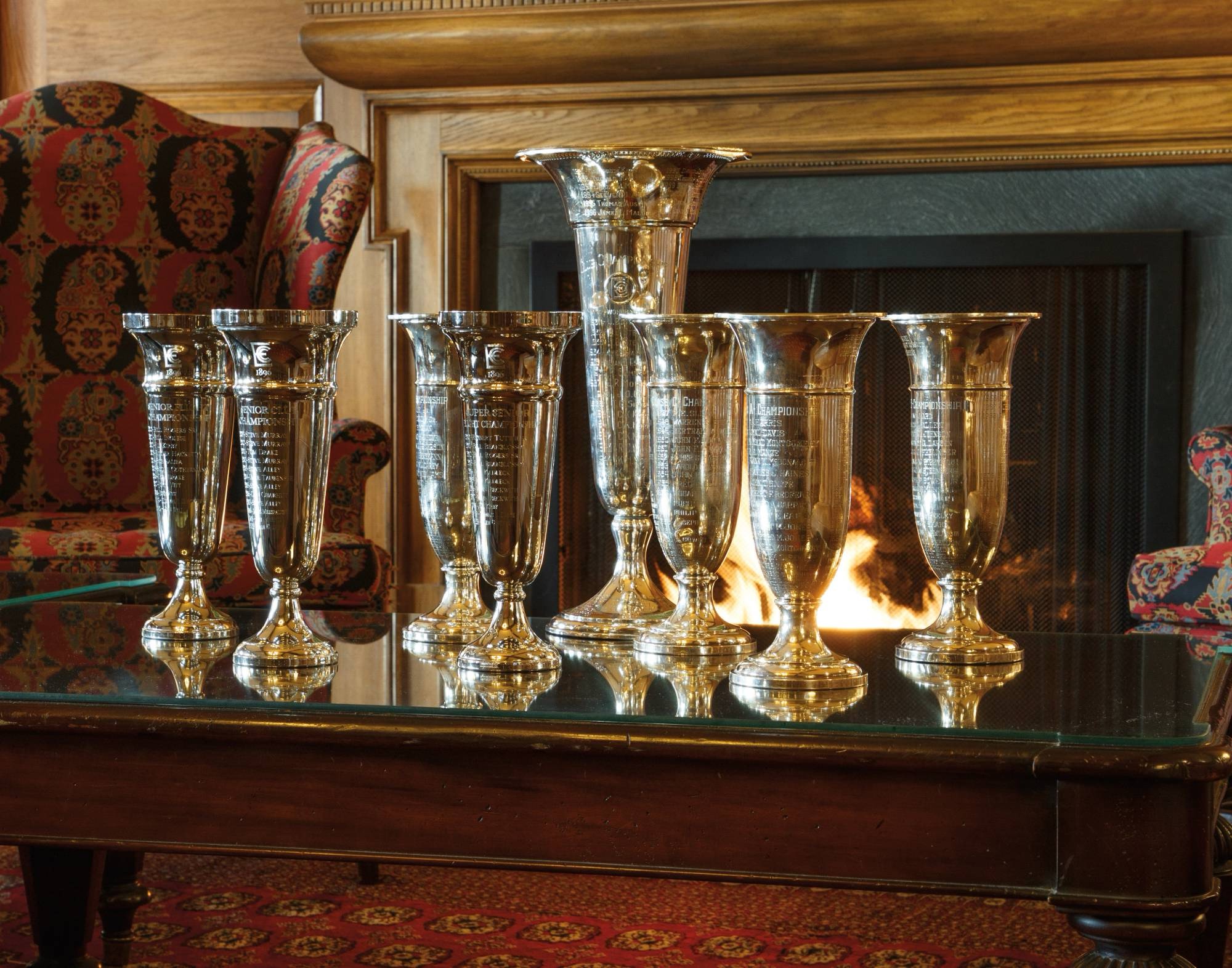 Club championship trophies by the fireplace
